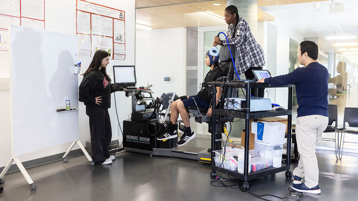 faculty and students using device in lab